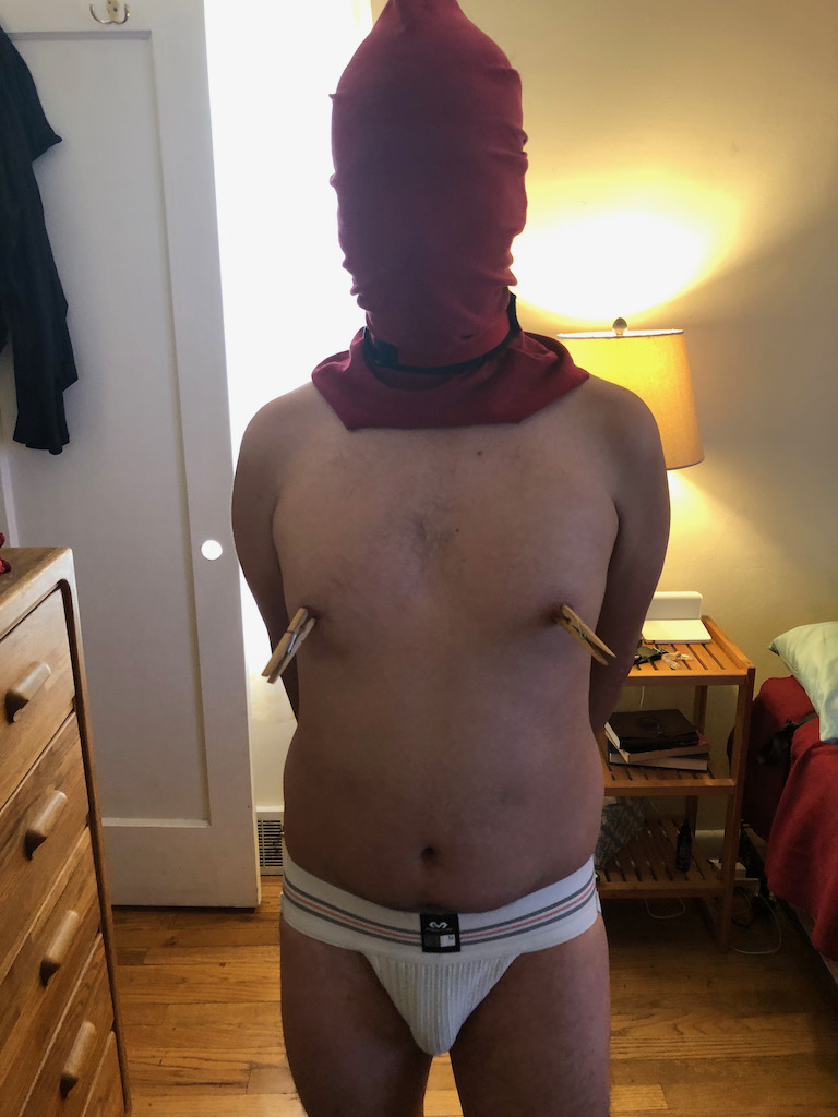 boy with hood and nipple clamps